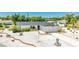 Beautiful one-story home with a white exterior, a well manicured yard and a concrete driveway at 6628 Keystone Dr, Sarasota, FL 34231