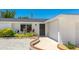 Home features an immaculate yard, a new roof and a sculpted concrete path leading to the front door at 6628 Keystone Dr, Sarasota, FL 34231