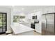 Modern white kitchen features stainless steel appliances and quartz countertops at 6628 Keystone Dr, Sarasota, FL 34231