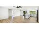 Bright, open living space with updated floors, fans, and a modern kitchen featuring an island at 6628 Keystone Dr, Sarasota, FL 34231