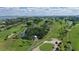 Aerial view of a lush golf course community with lake and waterway views at 675 Longboat Club Rd # 23A, Longboat Key, FL 34228