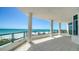 Large balcony with pillars overlooking white sandy beach at 675 Longboat Club Rd # 23A, Longboat Key, FL 34228