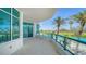 Spacious balcony with glass railings offers stunning views of the golf course and nearby buildings at 675 Longboat Club Rd # 23A, Longboat Key, FL 34228