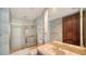 Bathroom with gold framed shower and sink with gold fixtures at 675 Longboat Club Rd # 23A, Longboat Key, FL 34228