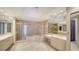 Luxurious bathroom with marble tiling, shower, soaking tub, and dual vanities at 675 Longboat Club Rd # 23A, Longboat Key, FL 34228