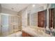 Well-lit bathroom features a shower with gold frame and a single sink vanity at 675 Longboat Club Rd # 23A, Longboat Key, FL 34228