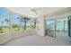 Bright bedroom featuring neutral carpet and large bay window with scenic view and balcony access at 675 Longboat Club Rd # 23A, Longboat Key, FL 34228