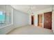 Light bedroom features carpet and doors that lead to another bedroom and bathroom at 675 Longboat Club Rd # 23A, Longboat Key, FL 34228