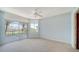 Spacious bedroom with a ceiling fan, carpet, and large sliding glass doors to a balcony at 675 Longboat Club Rd # 23A, Longboat Key, FL 34228