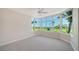 Bright bedroom featuring neutral carpet and large bay window with scenic golf course view at 675 Longboat Club Rd # 23A, Longboat Key, FL 34228