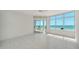 Bedroom featuring tile floors, and a sliding glass door to the balcony with ocean views at 675 Longboat Club Rd # 23A, Longboat Key, FL 34228