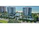 Beautiful condo buildings with manicured landscaping, palm trees, and a beachfront view at 675 Longboat Club Rd # 23A, Longboat Key, FL 34228