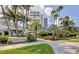 Elegant condominium entrance with lush tropical landscaping and beautiful signage at 675 Longboat Club Rd # 23A, Longboat Key, FL 34228