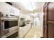 Long, narrow kitchen has stainless steel appliances, lots of counter space and white cabinets at 675 Longboat Club Rd # 23A, Longboat Key, FL 34228