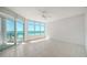 Bright and airy living room with tiled floor, large windows, and a sliding door that offers ocean view at 675 Longboat Club Rd # 23A, Longboat Key, FL 34228