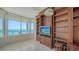 Living room featuring custom wood built-ins, tile flooring and recessed lighting, with view at 675 Longboat Club Rd # 23A, Longboat Key, FL 34228