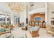 Spacious lobby features elegant chandelier, bar area with seating, and comfortable lounging areas at 675 Longboat Club Rd # 23A, Longboat Key, FL 34228