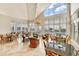 Elegant clubhouse lounge featuring multiple seating areas, large windows with ocean views, and stylish decor at 675 Longboat Club Rd # 23A, Longboat Key, FL 34228