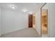 Neutral carpeted room, with a view to the spacious bathroom at 675 Longboat Club Rd # 23A, Longboat Key, FL 34228