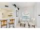 Charming dining area with adjacent breakfast bar and a view of the kitchen at 6770 Fairway Gardens Dr, Bradenton, FL 34203