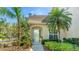 Charming home featuring lush landscaping and a welcoming front entrance with glass door at 6770 Fairway Gardens Dr, Bradenton, FL 34203