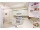 Bright kitchen features white cabinetry, modern appliances, mosaic tile backsplash, and decorative accents at 6770 Fairway Gardens Dr, Bradenton, FL 34203