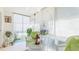 Cozy sunroom with wicker furniture, bird cage, and natural light from screened windows at 6770 Fairway Gardens Dr, Bradenton, FL 34203