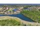 Panoramic aerial view of houses with lake views surrounded by golf courses and lush greenery at 7538 Camden Harbour Dr, Bradenton, FL 34212