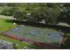 Aerial view of a community basketball court with a parking lot and mature landscaping at 7538 Camden Harbour Dr, Bradenton, FL 34212