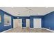 Spacious bedroom with blue walls, wood floors, open doorways, and ample closet space at 7538 Camden Harbour Dr, Bradenton, FL 34212