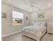 Well-lit bedroom features a ceiling fan, a window with blinds and an all white decor at 7538 Camden Harbour Dr, Bradenton, FL 34212