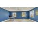 Spacious bedroom with blue walls, wood floors, with many windows and natural light at 7538 Camden Harbour Dr, Bradenton, FL 34212