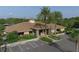 Exterior of clubhouse with parking, professional landscaping, and palm tree accents at 7538 Camden Harbour Dr, Bradenton, FL 34212