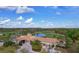 Aerial view of the clubhouse with a large pond and sprawling golf course in the background at 7538 Camden Harbour Dr, Bradenton, FL 34212