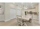 Eating area with simple table set, recessed lights, and adjacent kitchen with stainless appliances at 7538 Camden Harbour Dr, Bradenton, FL 34212
