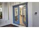 Beautiful entryway with glass-paneled blue double doors and stylish lighting at 7538 Camden Harbour Dr, Bradenton, FL 34212