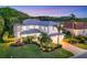 Beautiful home showcasing lush landscaping, a well-manicured lawn, and a brick driveway at 7538 Camden Harbour Dr, Bradenton, FL 34212