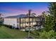A two-story home features a screened-in pool enclosure and landscaping at 7538 Camden Harbour Dr, Bradenton, FL 34212