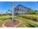 Exterior of home with a screened-in pool area and beautifully landscaped yard at 7538 Camden Harbour Dr, Bradenton, FL 34212