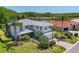 A two-story home features a tile roof, landscaping, and a view of the lake at 7538 Camden Harbour Dr, Bradenton, FL 34212