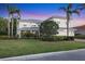 Attractive home featuring a lush lawn, manicured shrubs, and a quaint screened porch at 7538 Camden Harbour Dr, Bradenton, FL 34212