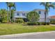 Beautiful two story home featuring meticulously maintained landscaping, a lush front lawn, and a white tile roof at 7538 Camden Harbour Dr, Bradenton, FL 34212