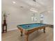 Spacious game room featuring a pool table, light wood floors, and neutral walls at 7538 Camden Harbour Dr, Bradenton, FL 34212