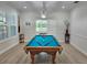Game room with a pool table, light wood floors, and shuttered windows at 7538 Camden Harbour Dr, Bradenton, FL 34212