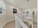 Upstairs hallway features a pendant light, light walls and luxury vinyl plank floors at 7538 Camden Harbour Dr, Bradenton, FL 34212