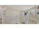 Second floor hallway with white railings, light floors and a view of the first floor at 7538 Camden Harbour Dr, Bradenton, FL 34212