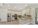 Well-lit kitchen featuring stainless steel appliances, granite counters, and neutral cabinetry at 7538 Camden Harbour Dr, Bradenton, FL 34212