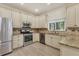 Bright kitchen with stainless steel appliances, granite countertops, and light cabinetry at 7538 Camden Harbour Dr, Bradenton, FL 34212
