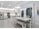 Bright kitchen with stainless steel appliances, white cabinets, and a large dining area at 7538 Camden Harbour Dr, Bradenton, FL 34212