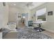 Bright home office with a ceiling fan, light wood floors, and a patterned blue rug at 7538 Camden Harbour Dr, Bradenton, FL 34212